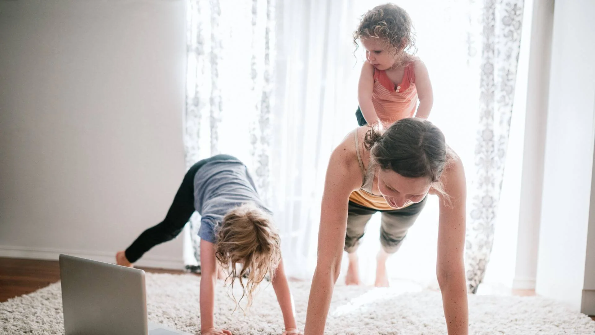 mom exercising online with her children