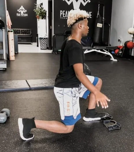 person kneeling to stretch knee pain