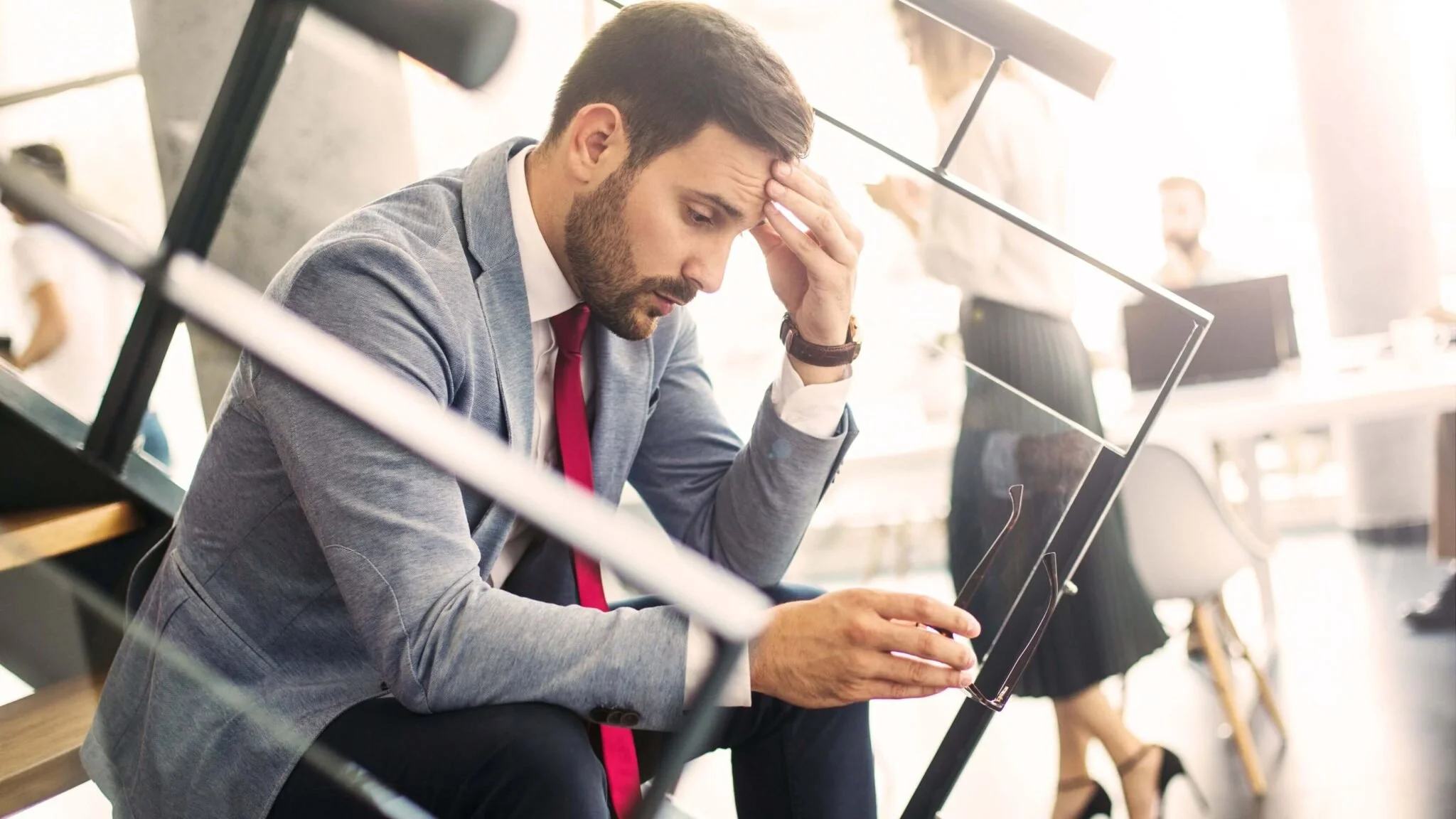 man looking very stressed at work