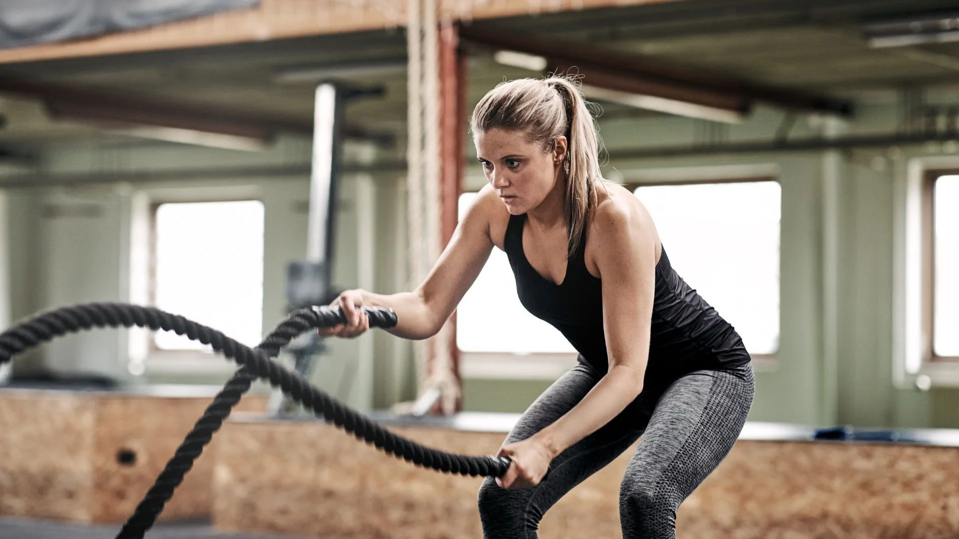 woman exercising in a personal training gym using robes
