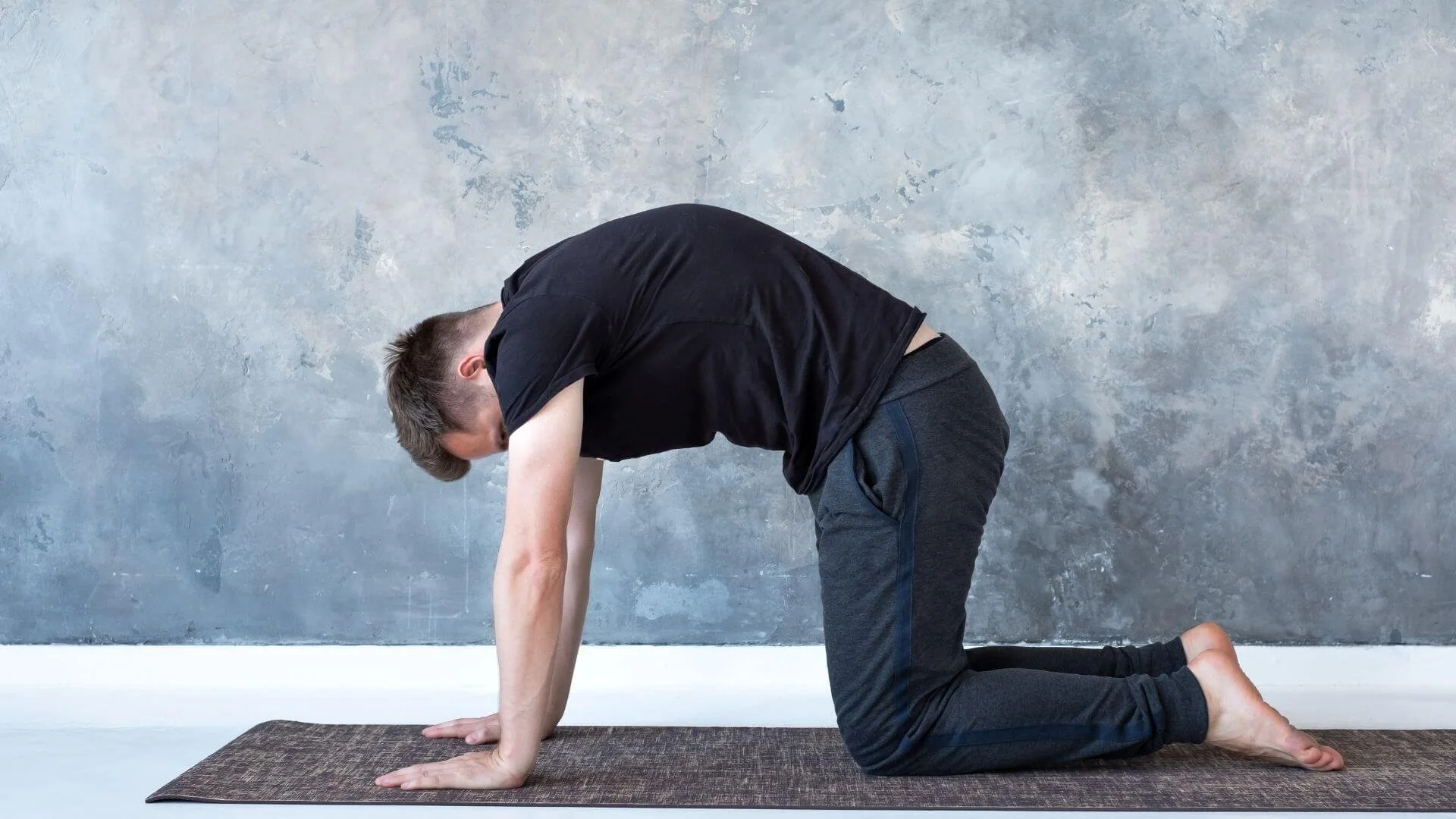 man doing a Cat-Cow Mobility exercise to help his lower back