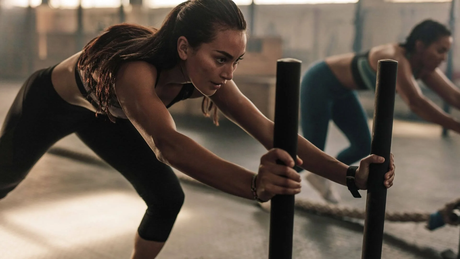 two women exercising in a gym