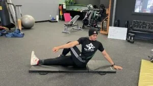 personal trainer showing how to do a Seated Spinal Twist