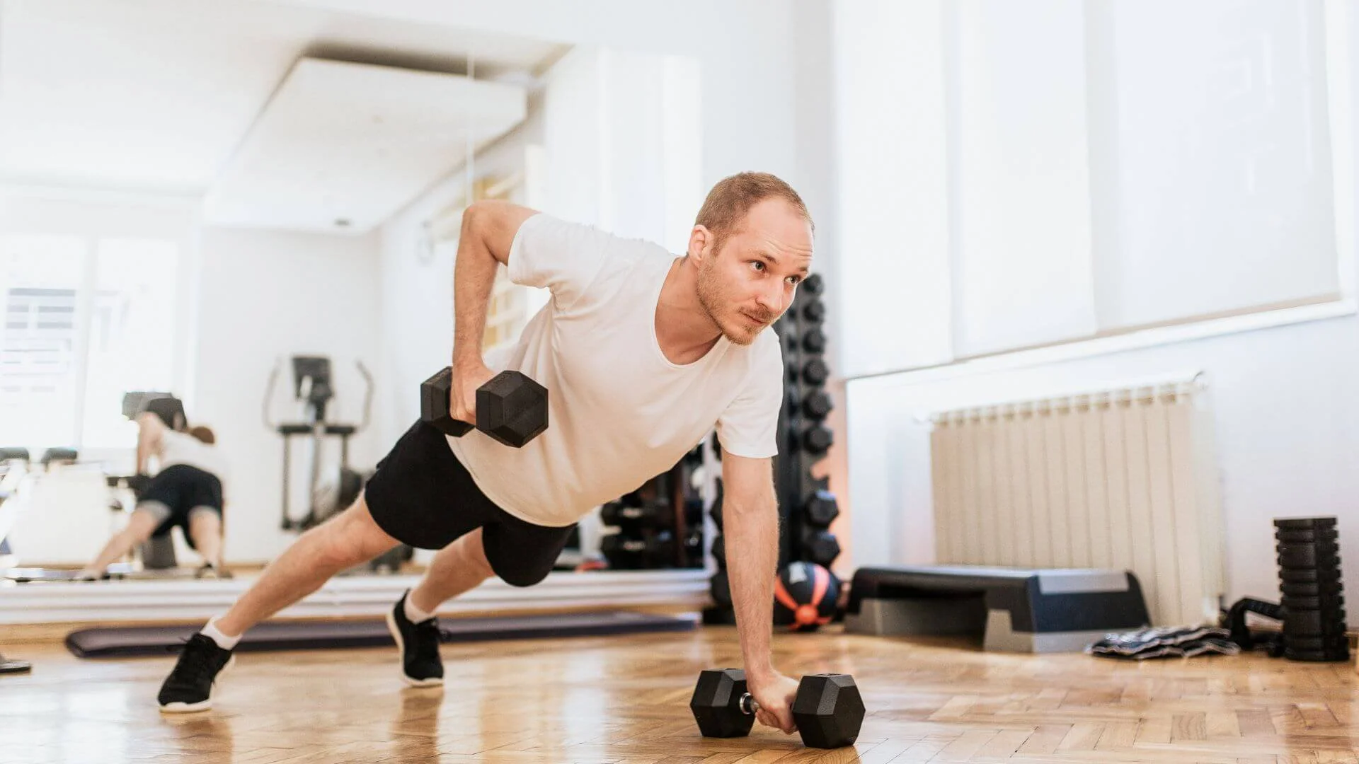 man lifting his dumbbell while exercising