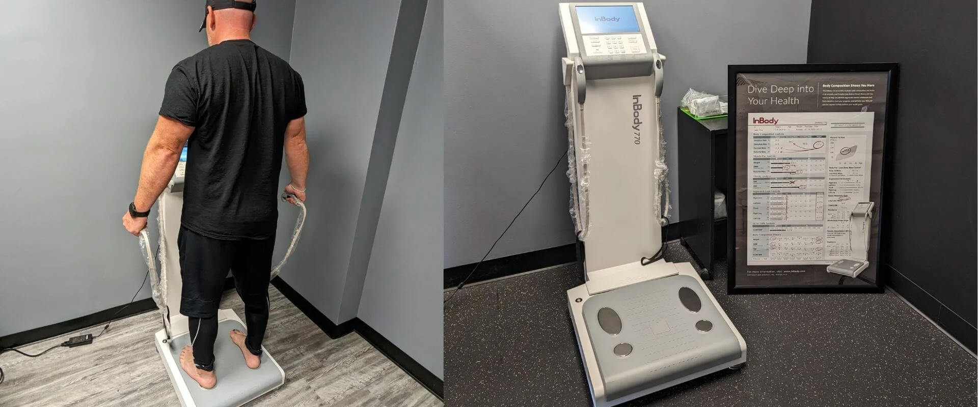 A man standing on a digital weight scale in a room with gray walls, holding onto the handles of a body composition analyzer machine. The right side of the image shows the body composition machine beside a framed health report.