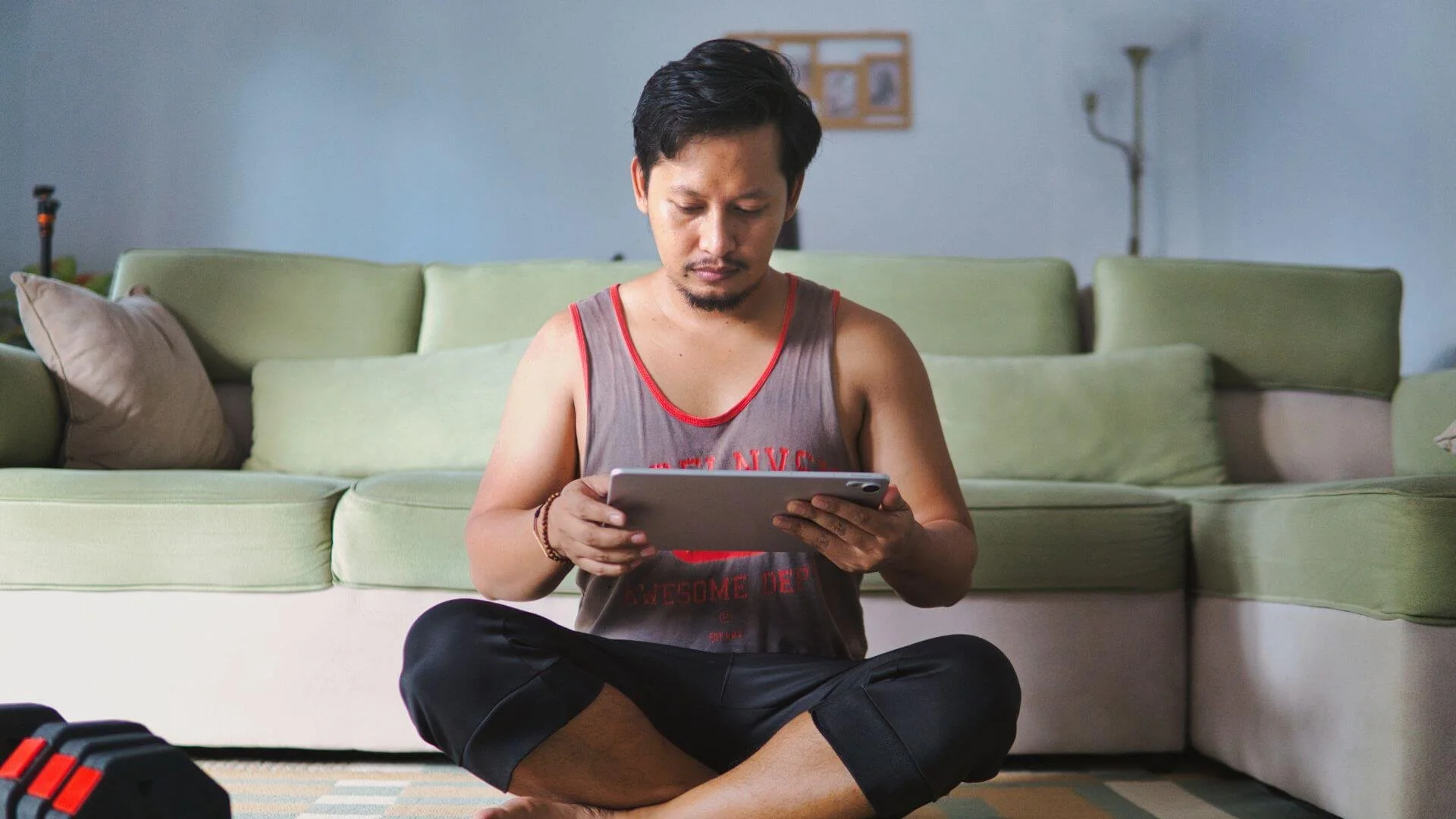 a man setting up his tablet for an online workout