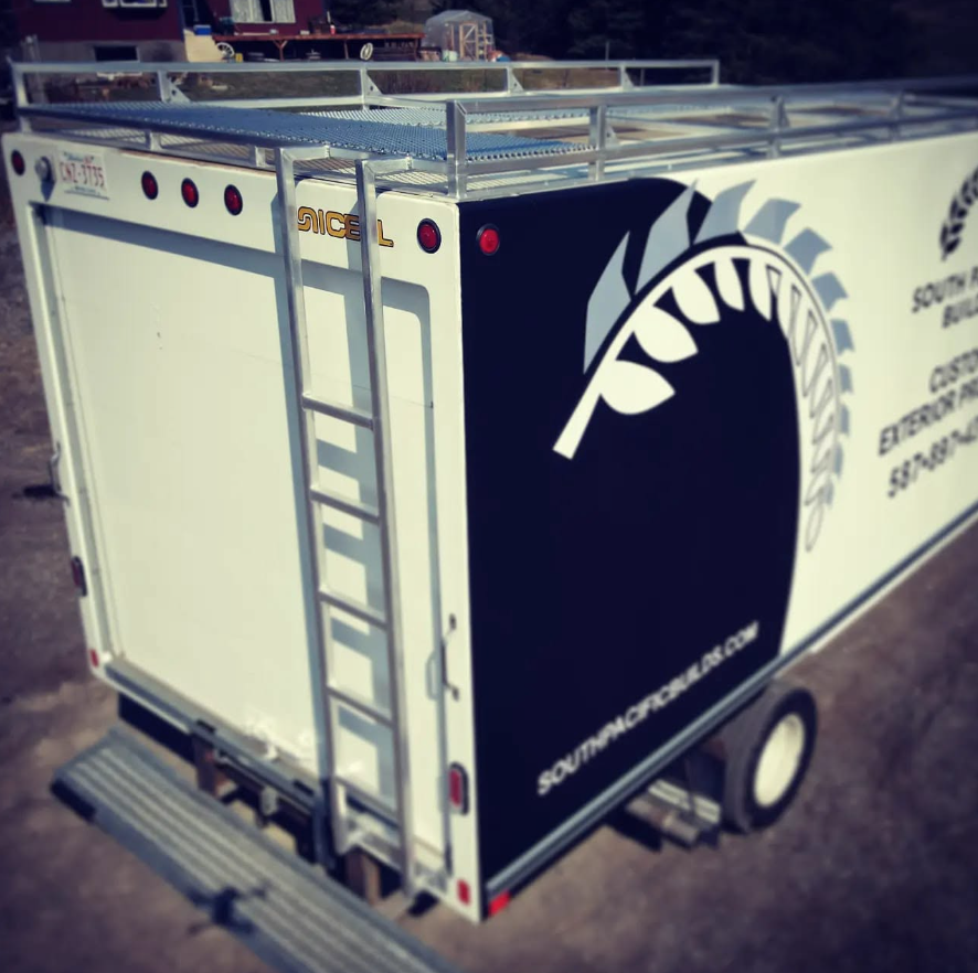 A moving truck with a large logo of a football and leaves, advertising a South Carolina football team.
