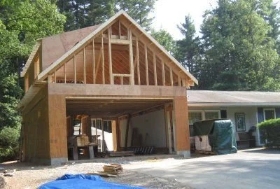 A house under construction with wooden framing and an unfinished second. Richmond VA central based home construction company, specializing in new homes, renovations, additions