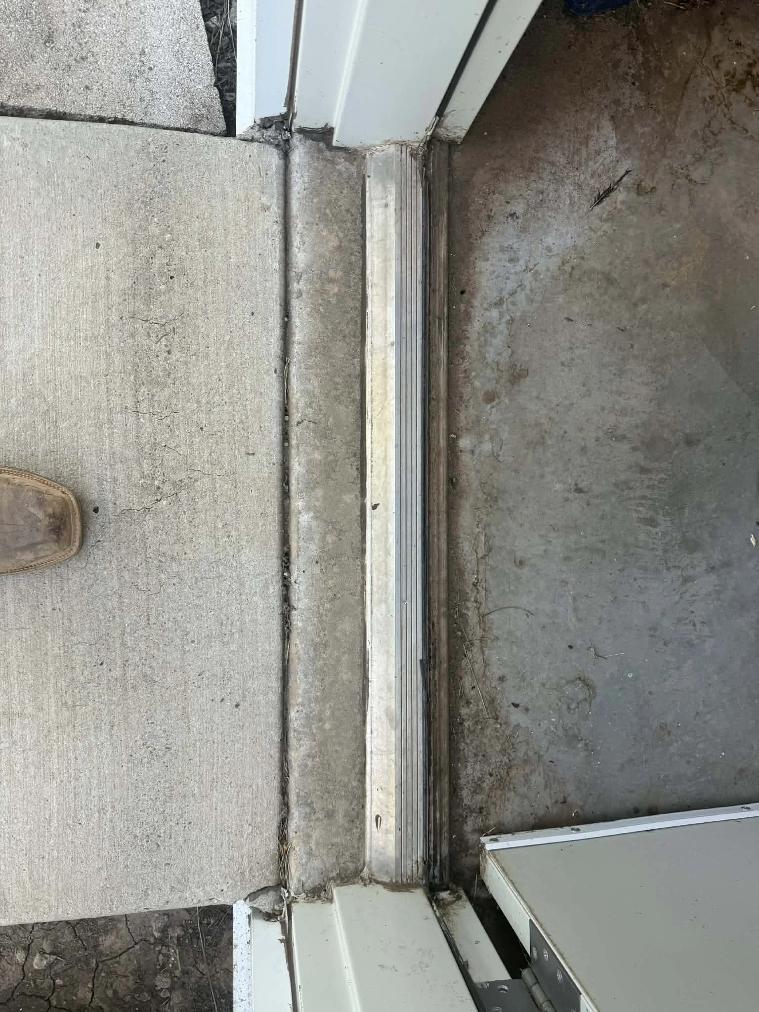 Replaced a worn door threshold to improve the seal, functionality, and appearance of the doorway. 
