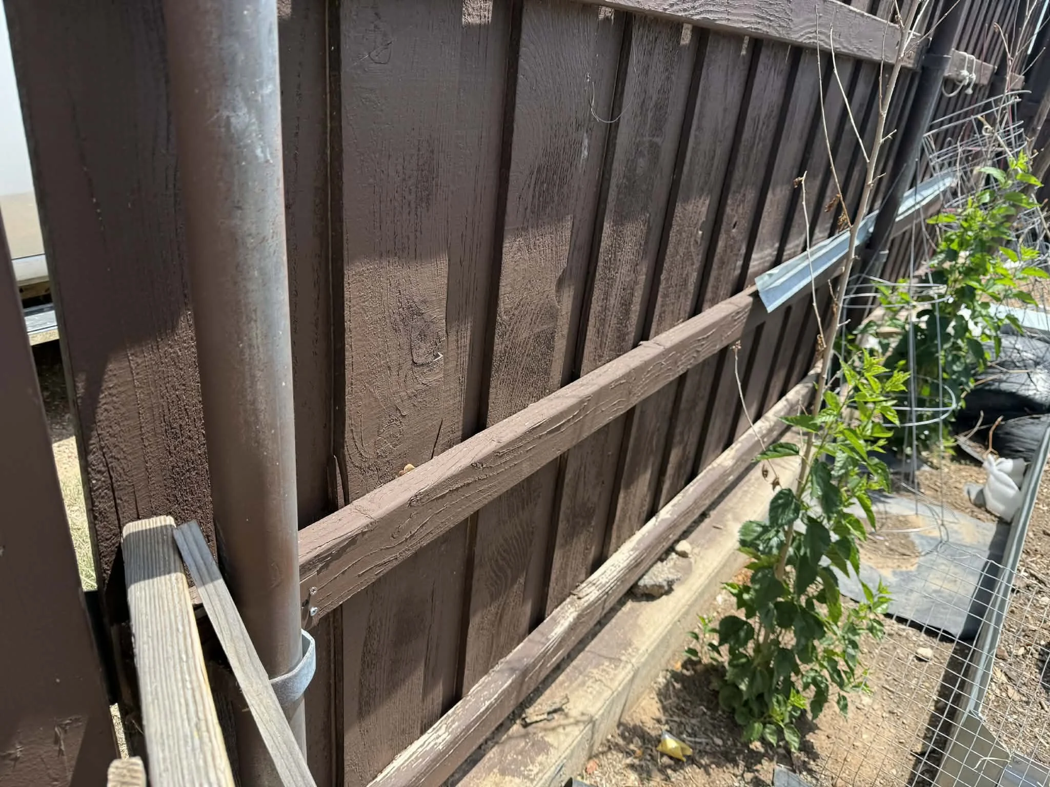 Repaired and reinforced the fence for improved durability and a clean, finished look.