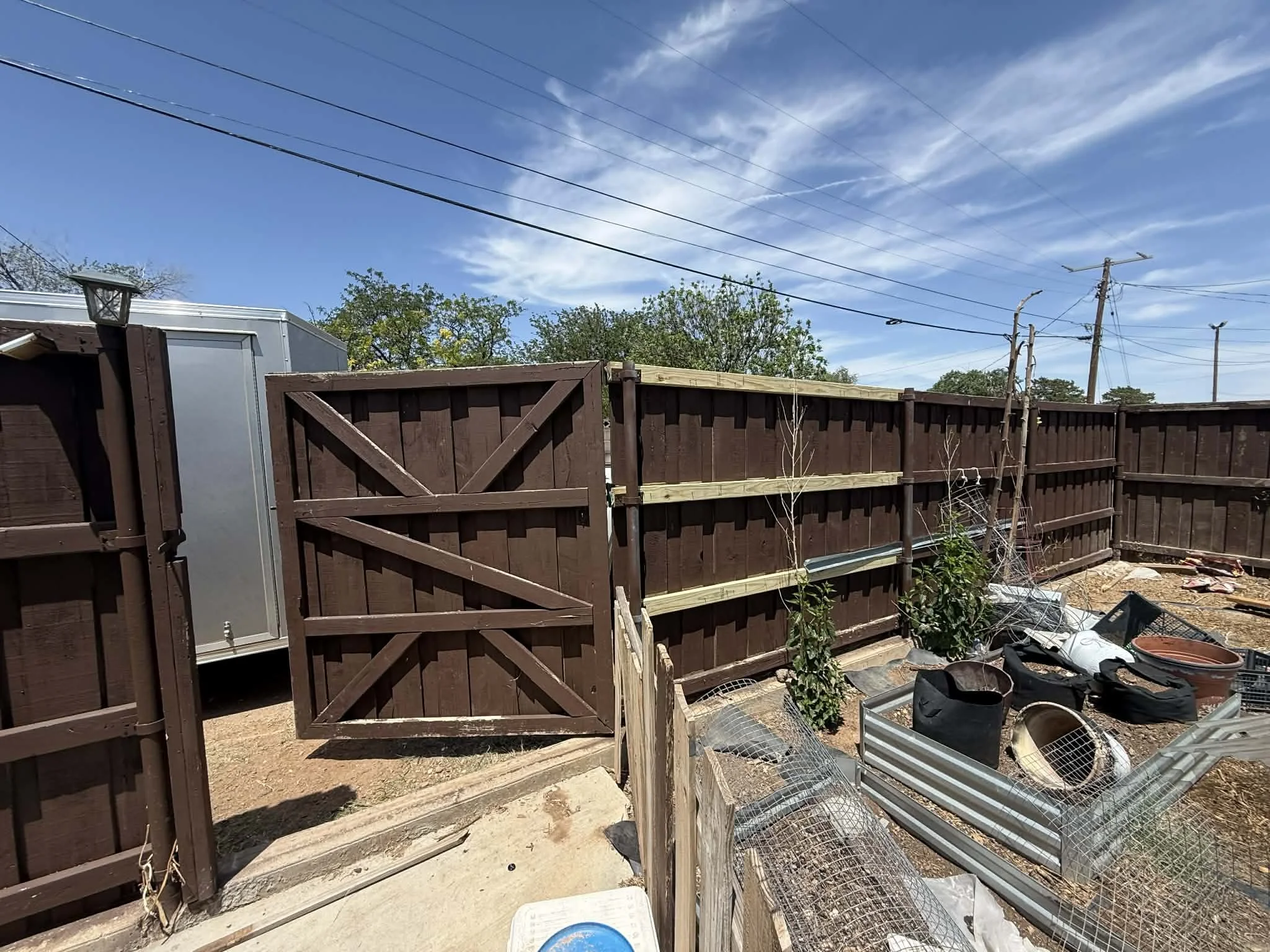 Repaired and reinforced the fence for improved durability and a clean, finished look.