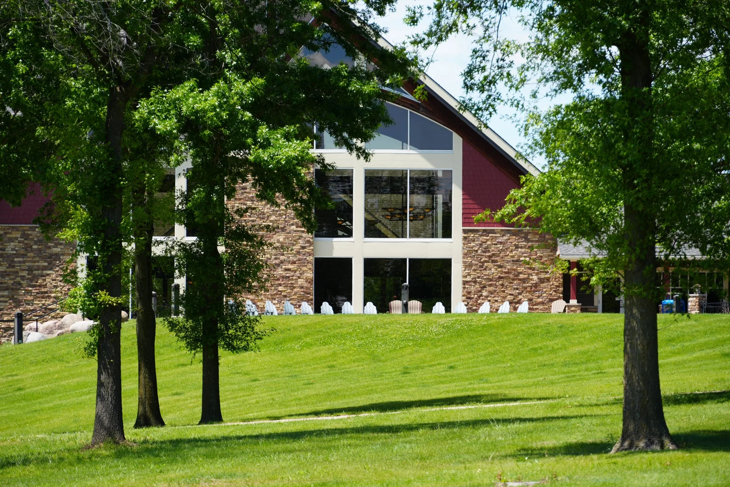 Honey Creek Resort's lawn and lodge surrounded by trees
