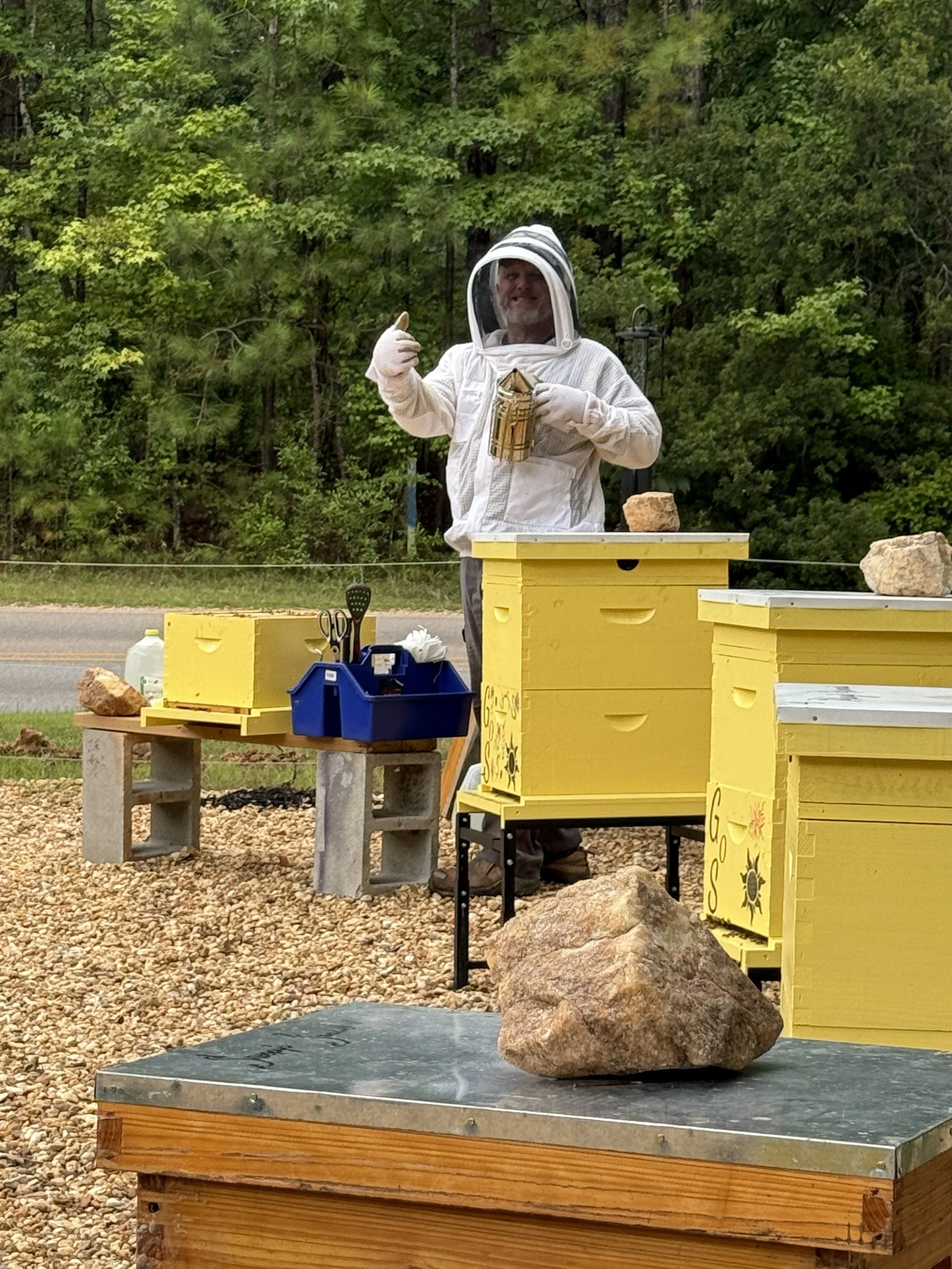 Harry tending the beehives at the apiary.