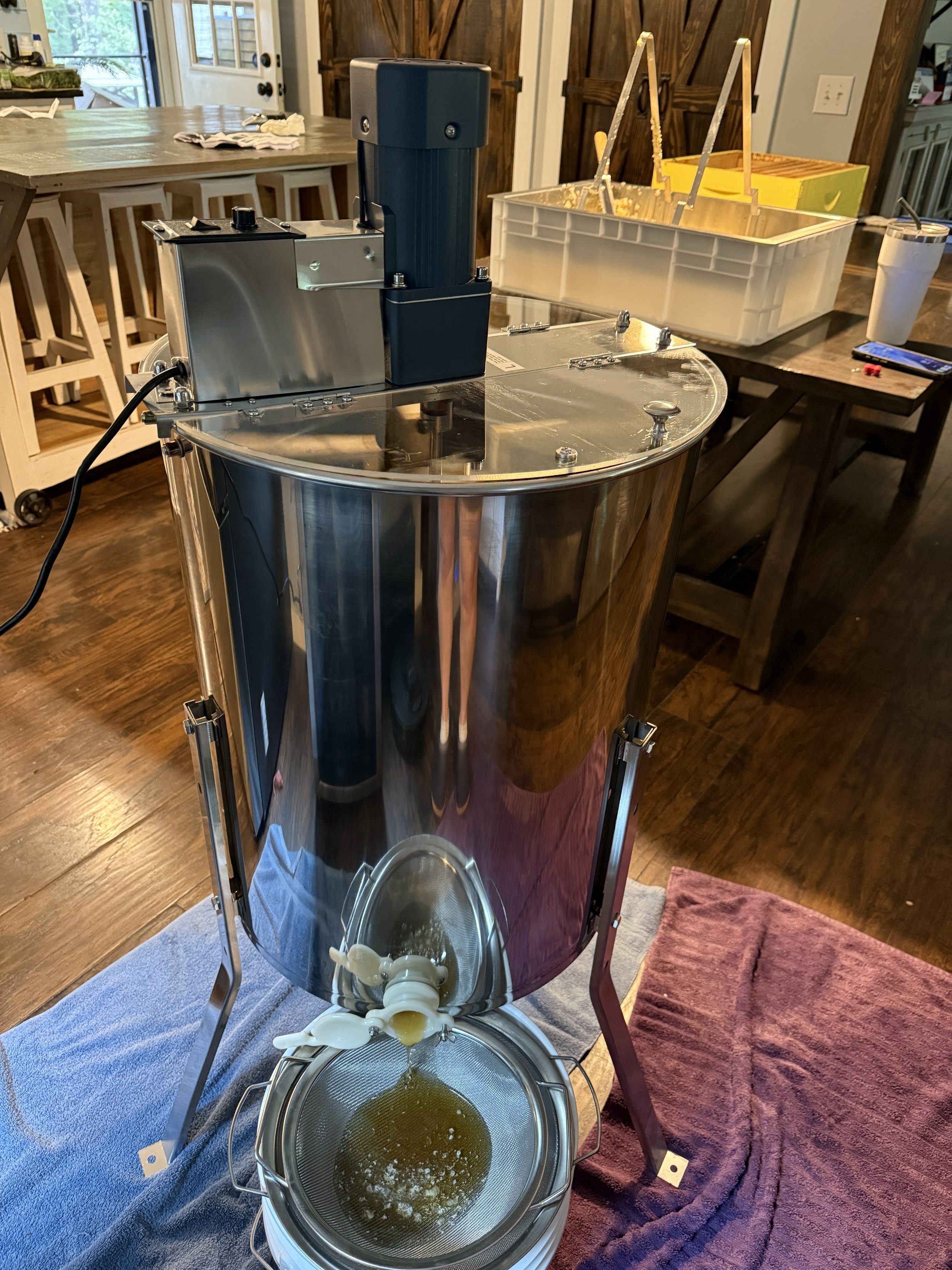 Stainless steel honey extraction equipment used for small-batch production.
