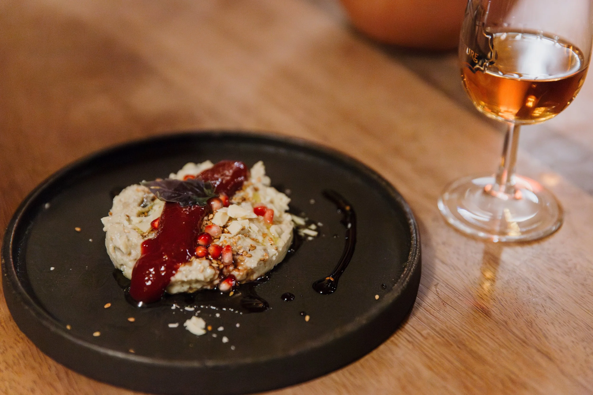 A whisky pairing photo where a dessert is accompanied by a glass of single malt scotch whisky.