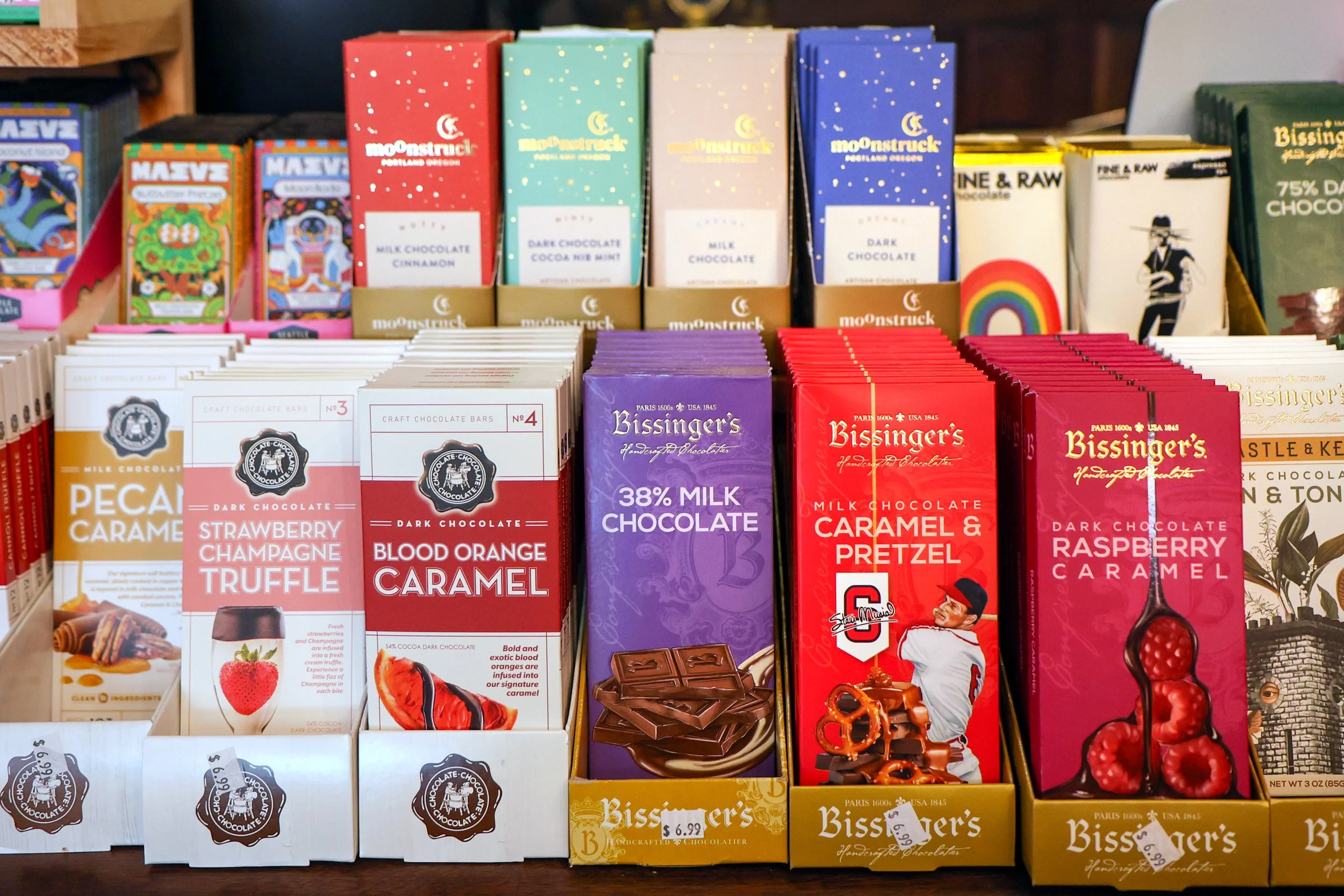Various colorful boxes of chocolate bars on displaystore shelf.