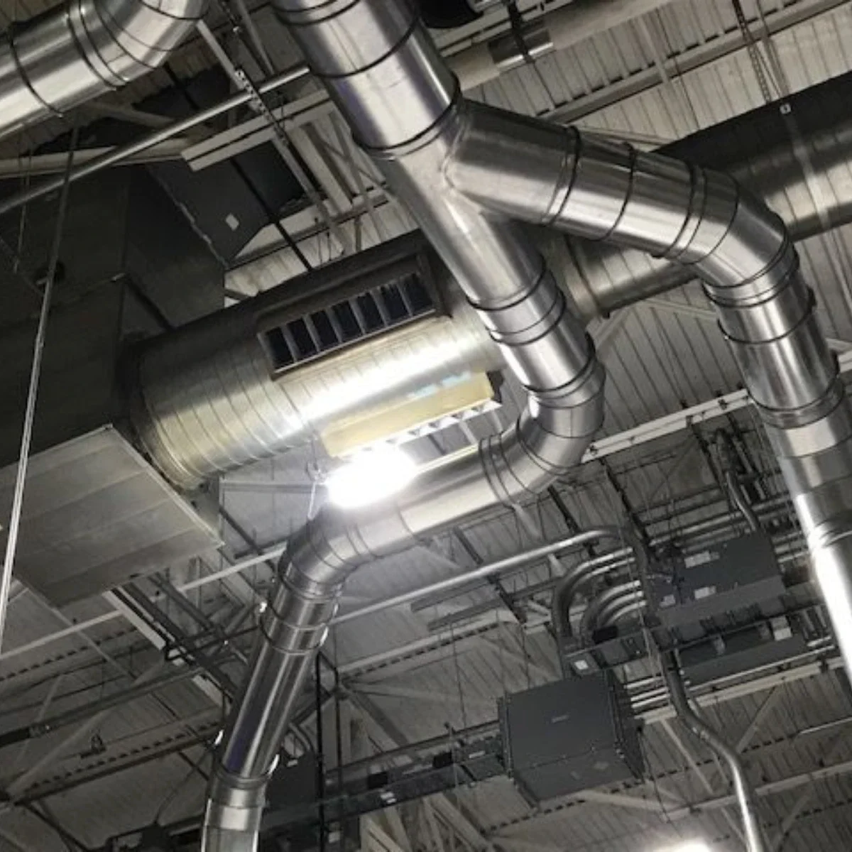 Industrial ceiling with metal ductwork and ventilation system.
