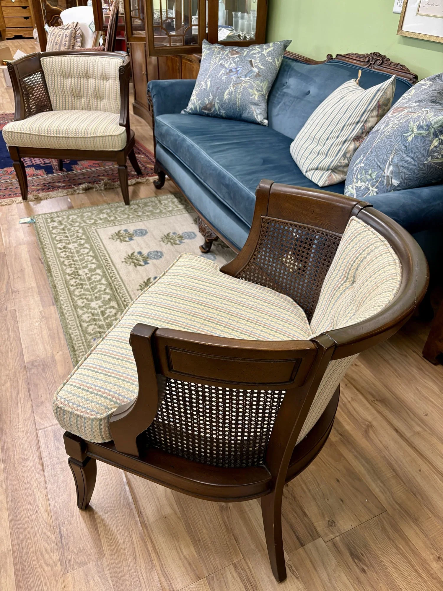 Pair of caned side chairs with tufted backs in pastel striped fabric and comfortable cushions, side view 02, Evelyn's Emporium Saint Paul