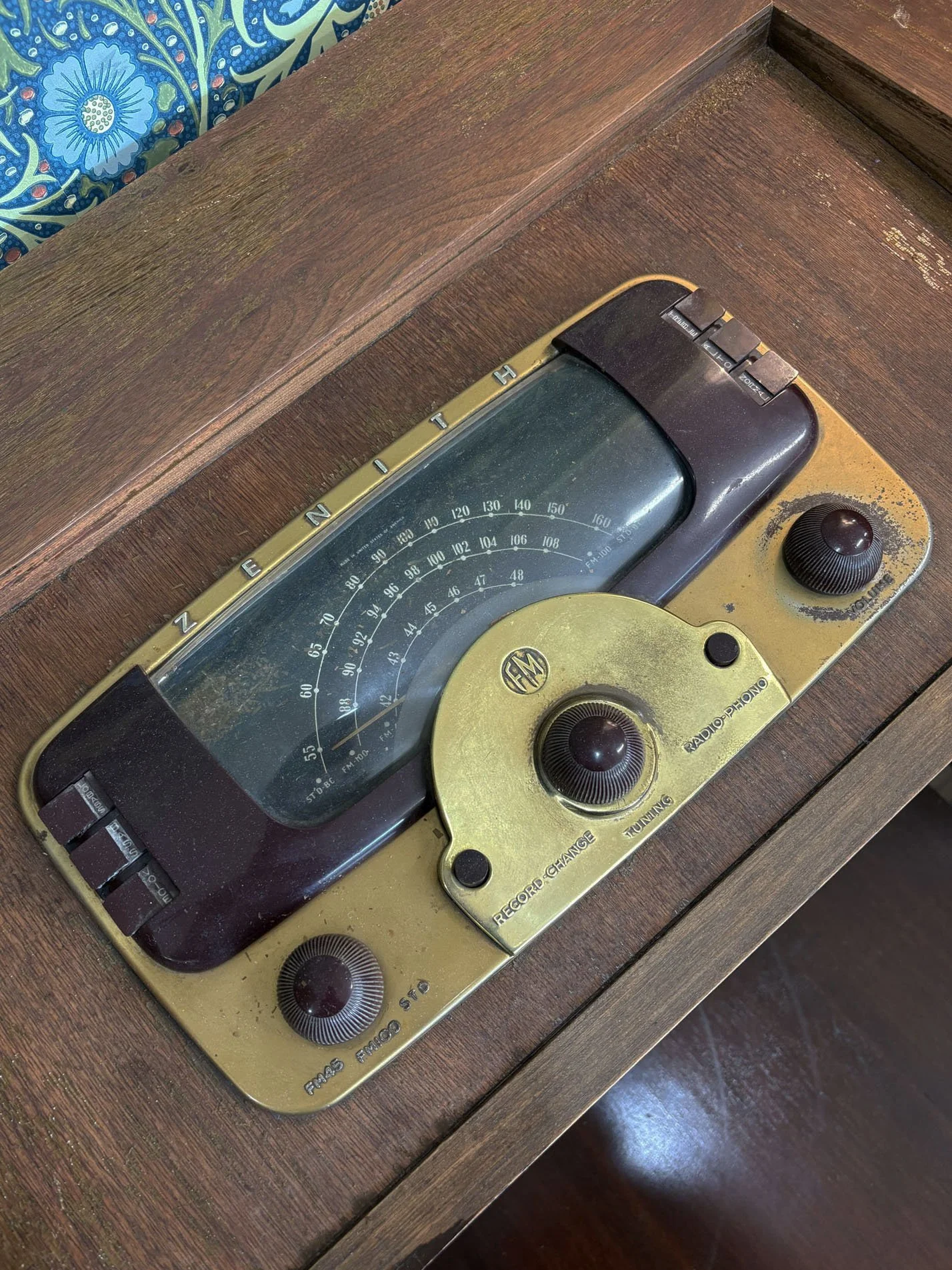 1950s Zenith radio phonograph console with burled wood and brass diamond-lattice grille, detail of the radio dial, Evelyn's Emporium Saint Paul