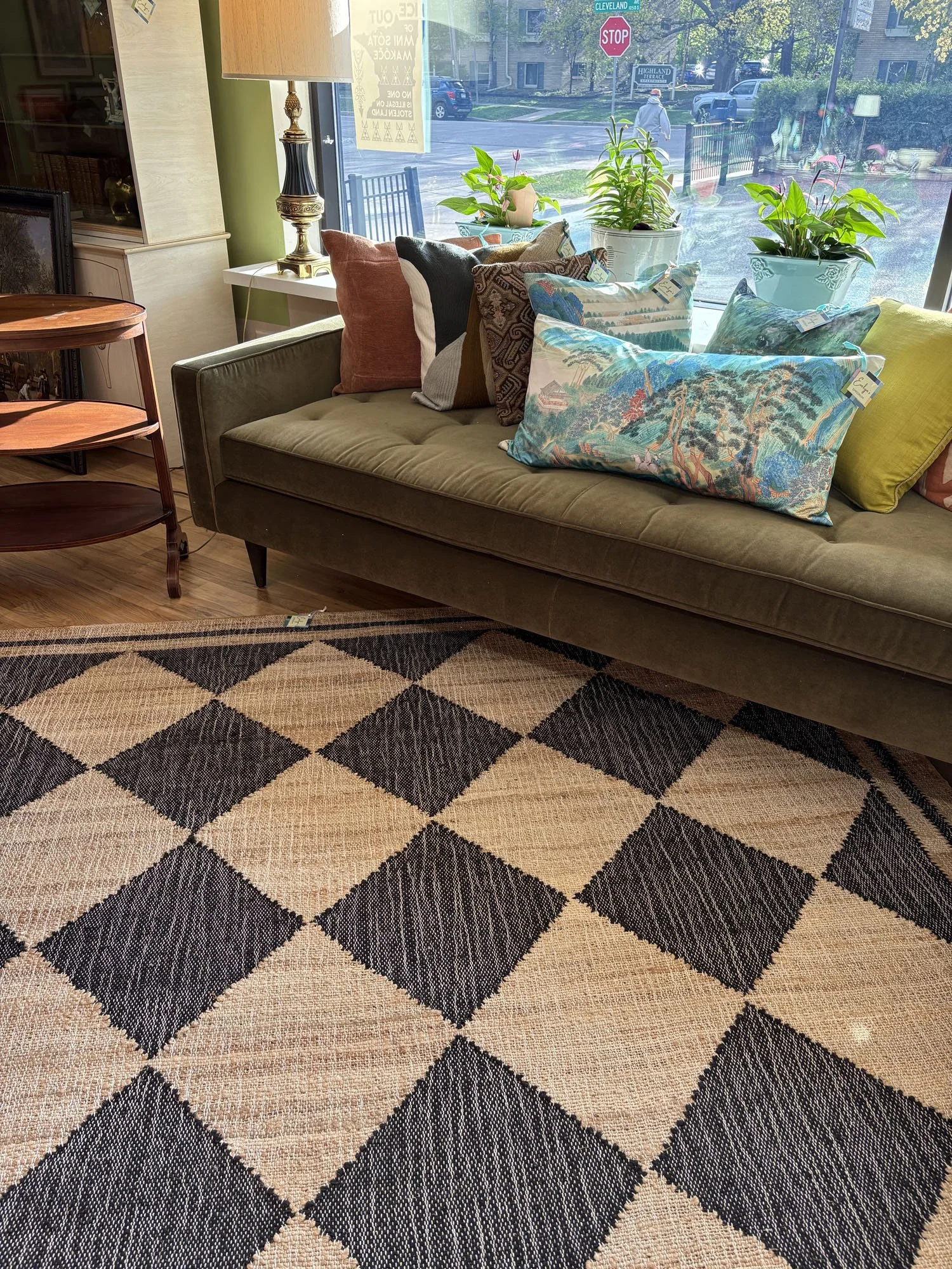 Hand-woven jute and wool checkered area rug with classic block print pattern, shown with a sofa and bar cart, Evelyn's Emporium Saint Paul