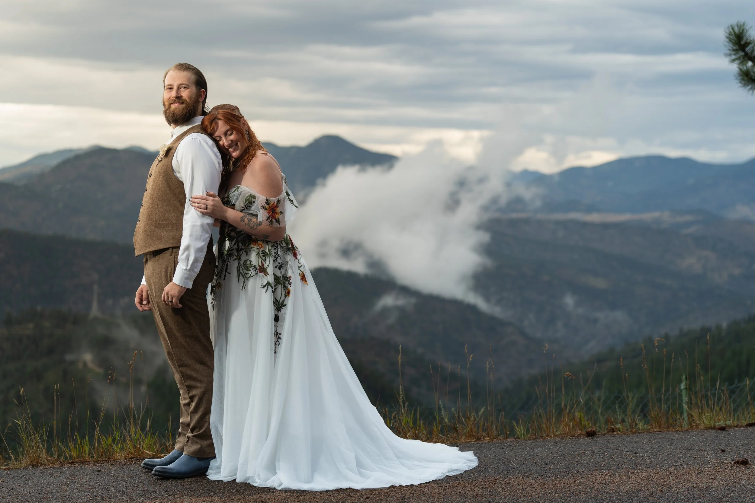 Picture of couple with low lying clouds and mountains