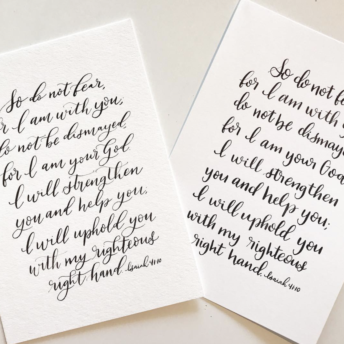 Two white cards with handwritten biblical verses from Isaiah 41:10, written in elegant cursive script.
