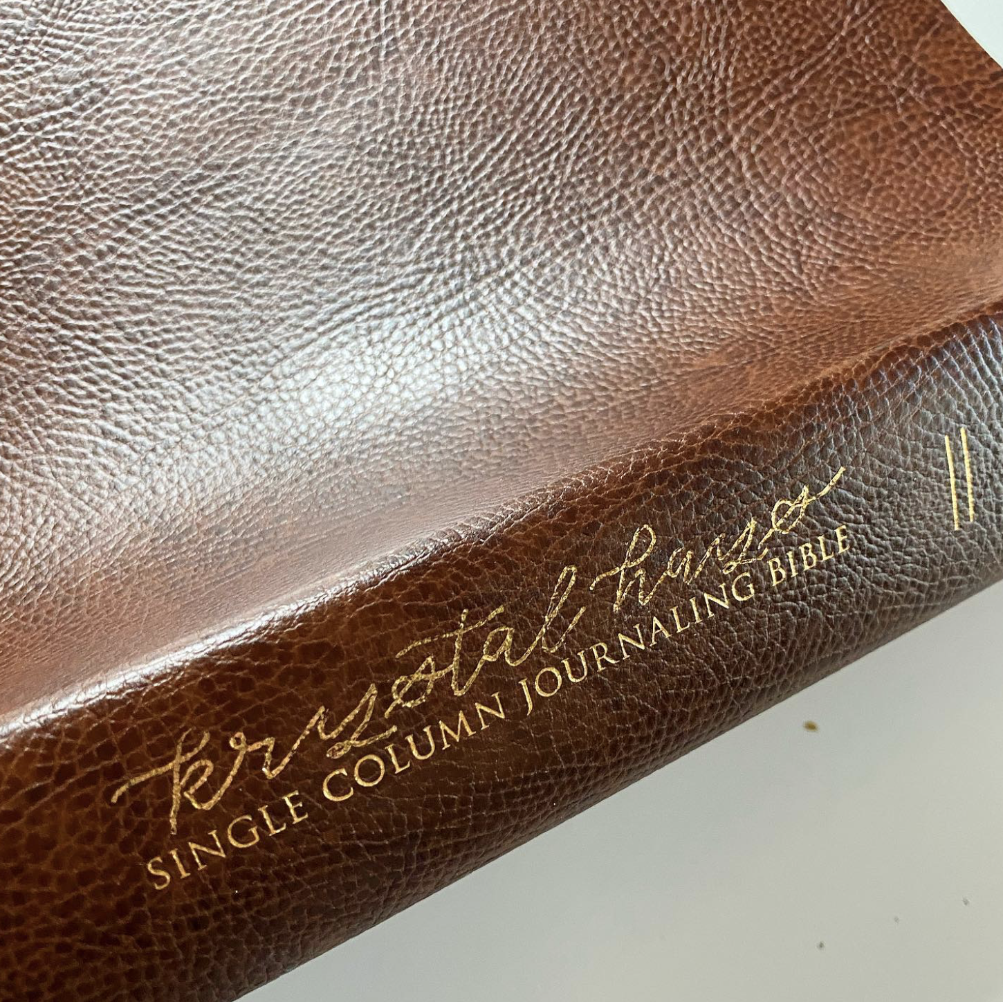 Close-up of a brown leather-bound book titled 'The Art of Journalism' with additional gold lettering.