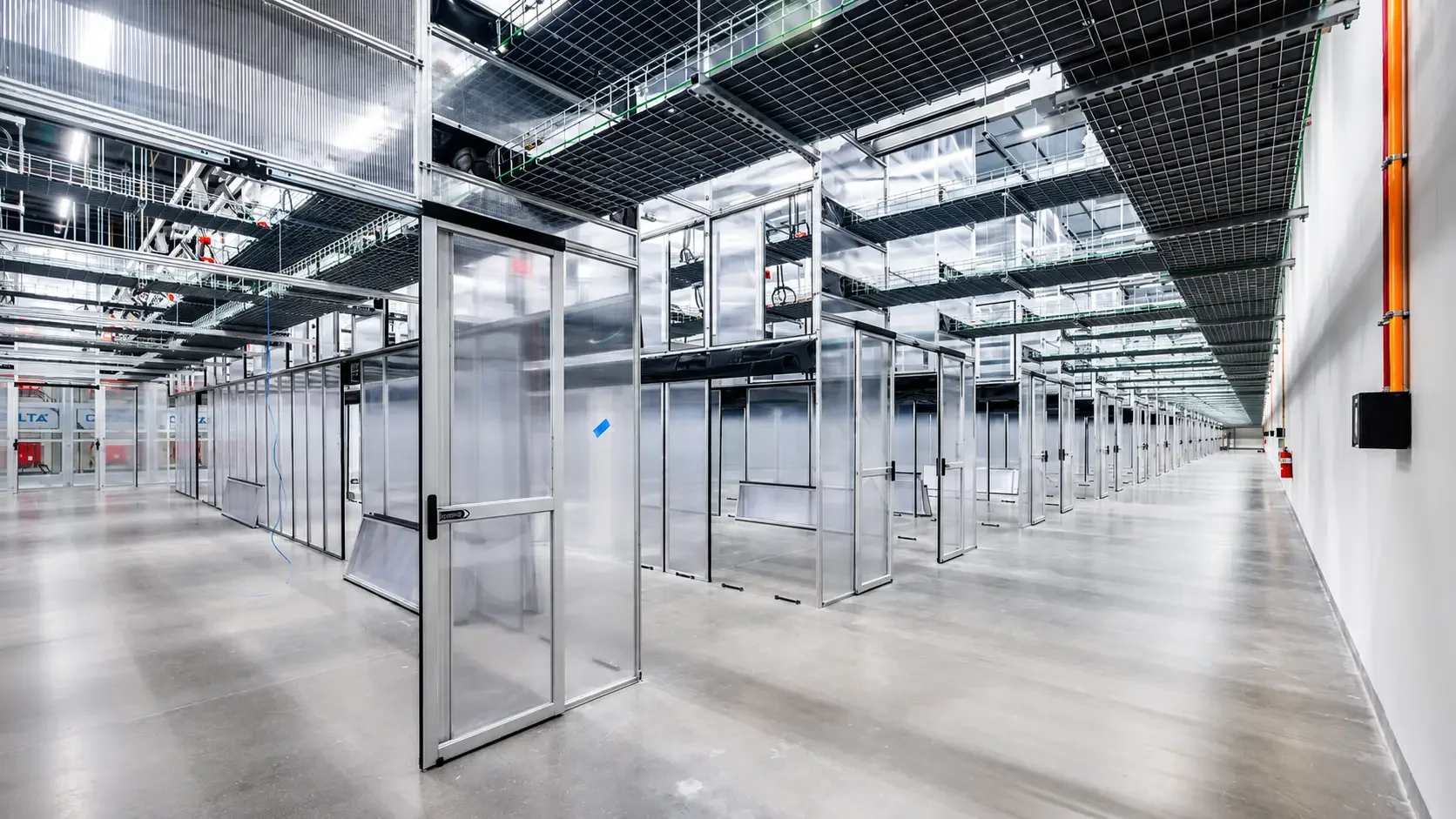 Empty industrial or technological facility with metal framing and walkways, possibly under construction or renovation.