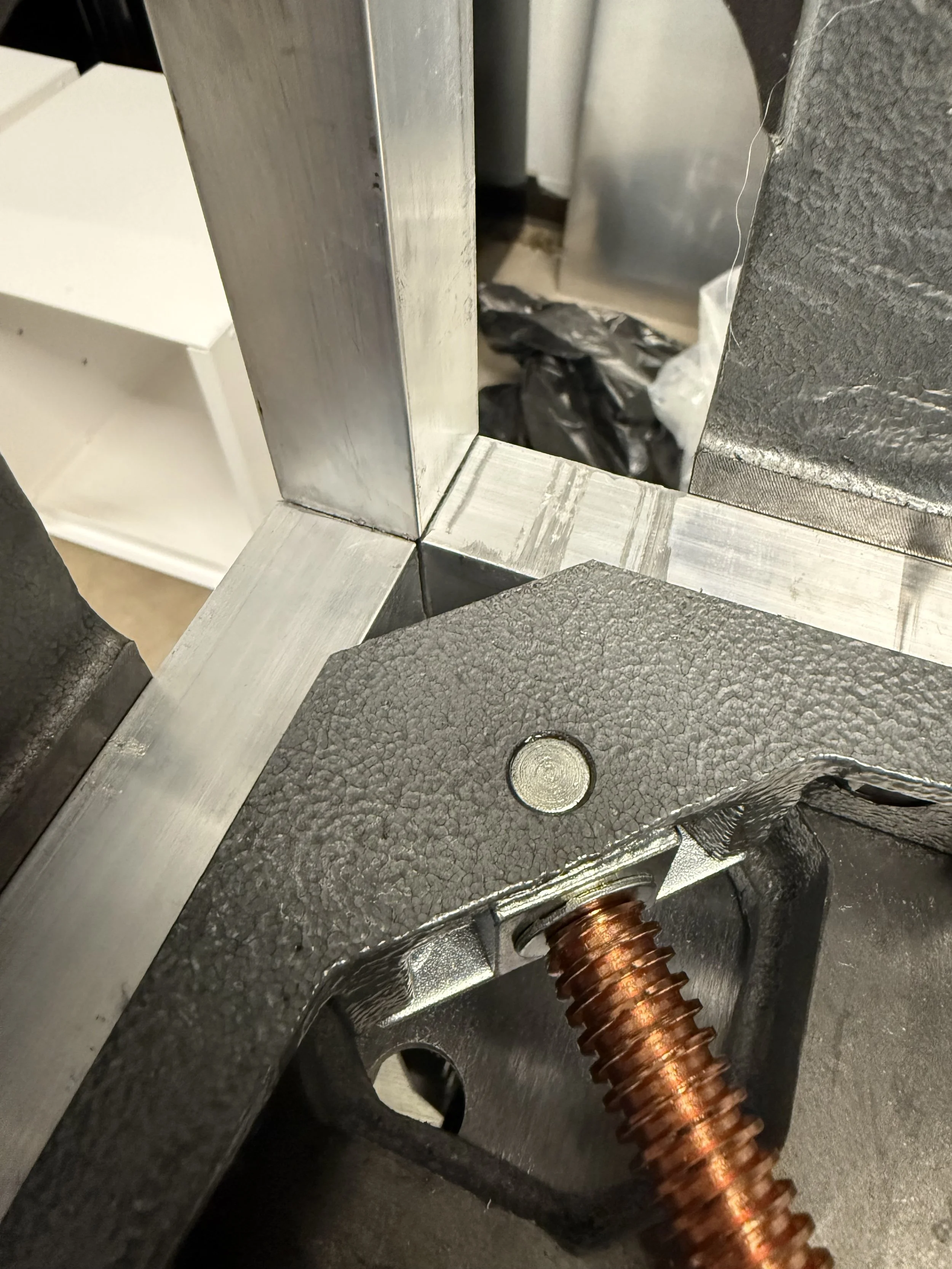 Corner fixture showing how square aluminum tube is joined for the reptile enclosures
