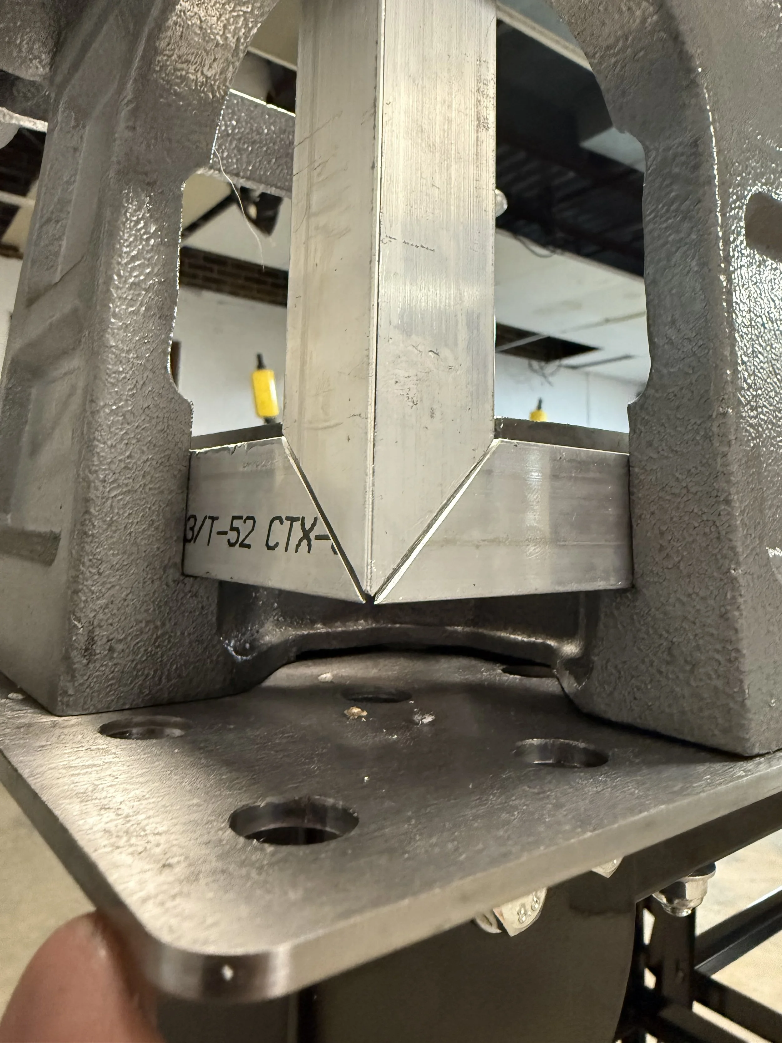 Close-up corner fixture showing how square aluminum tube is joined for the reptile enclosures