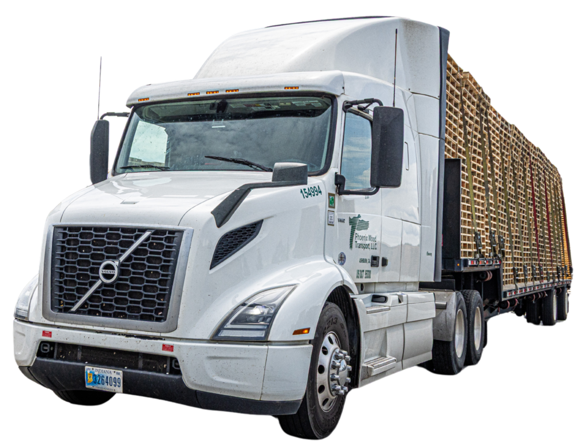 White semi-truck carrying wooden pallets labeled Phoenix Wood Transport LLC.