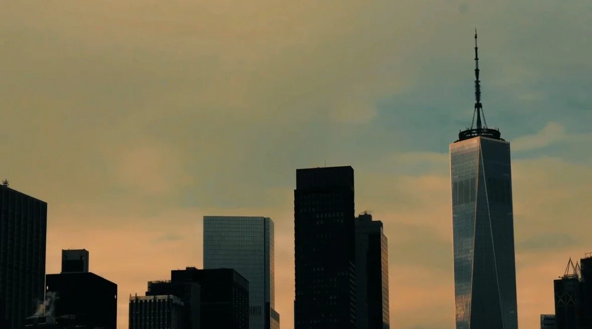 Skyline of New York City with One World Trade Center at sunset.