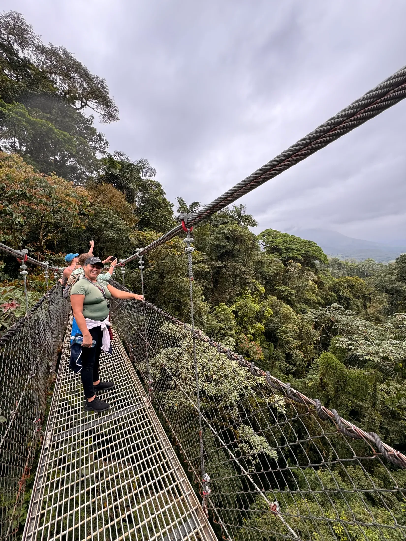 Group walking on a suspension bridge in Costa Rica