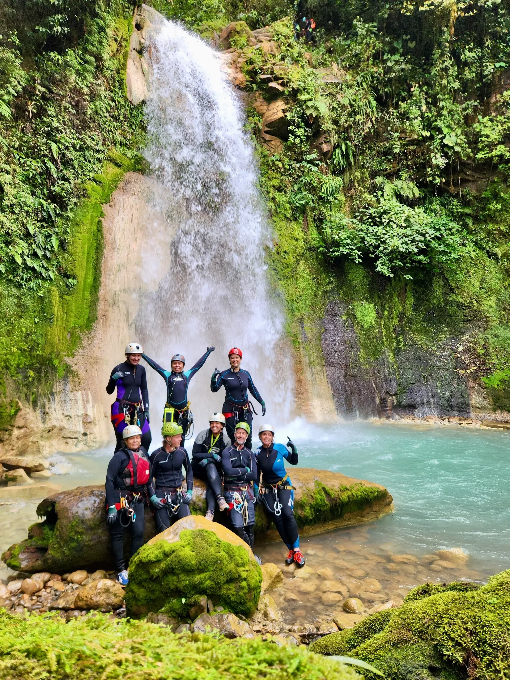Group of vacationers enjoying a waterfall and the jungles of Costa Rica