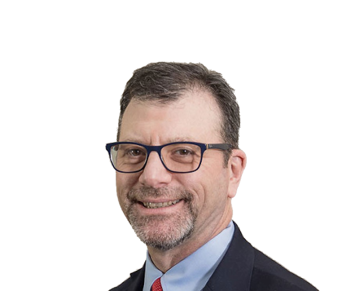 A professional man with glasses, wearing a suit and tie, smiling at the camera against a white background.