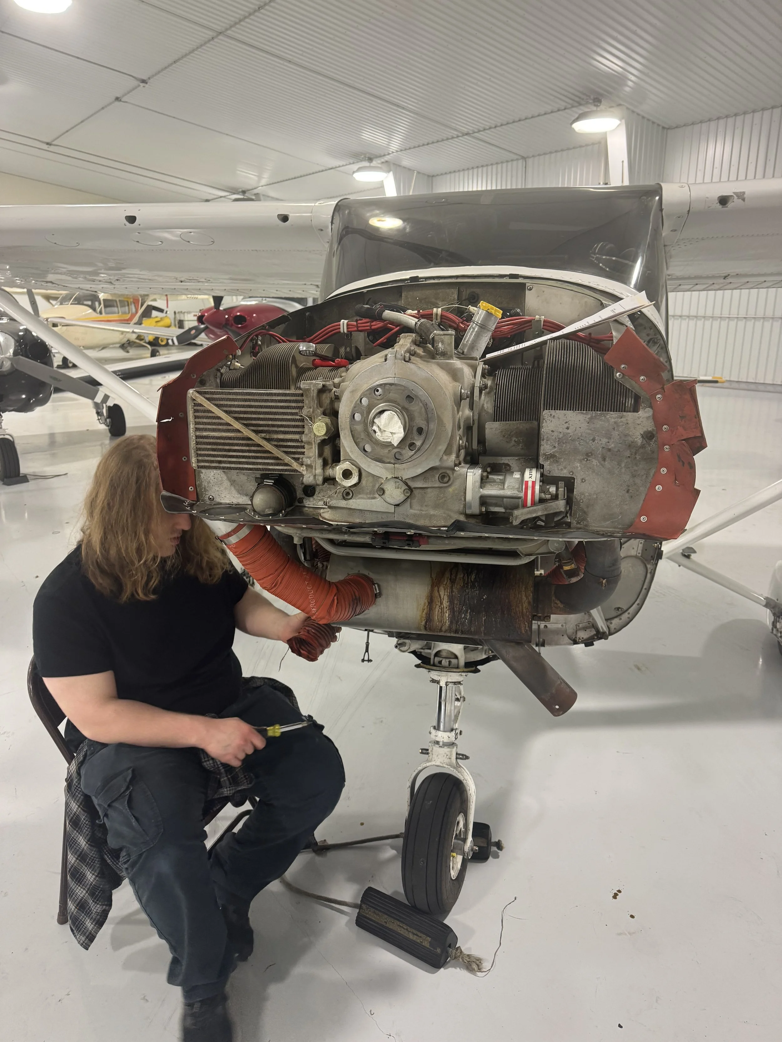 A mechanic working to replace the Crank seal on a Cessna 182.