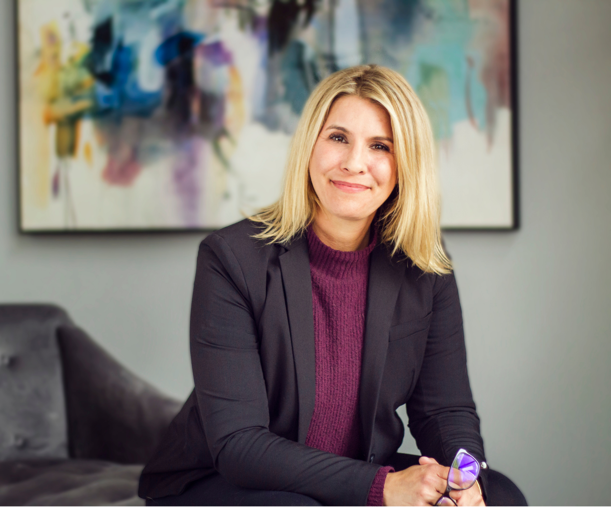Portrait: Professional portrait of a therapist and coach in a warm Austin office setting