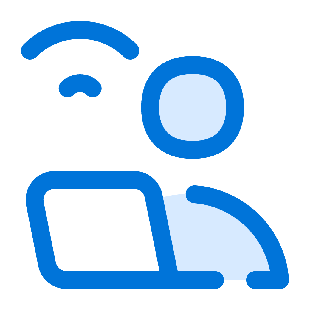 Simplified blue and white icon of a person sitting at a desk using a computer with a Wi-Fi signal above.