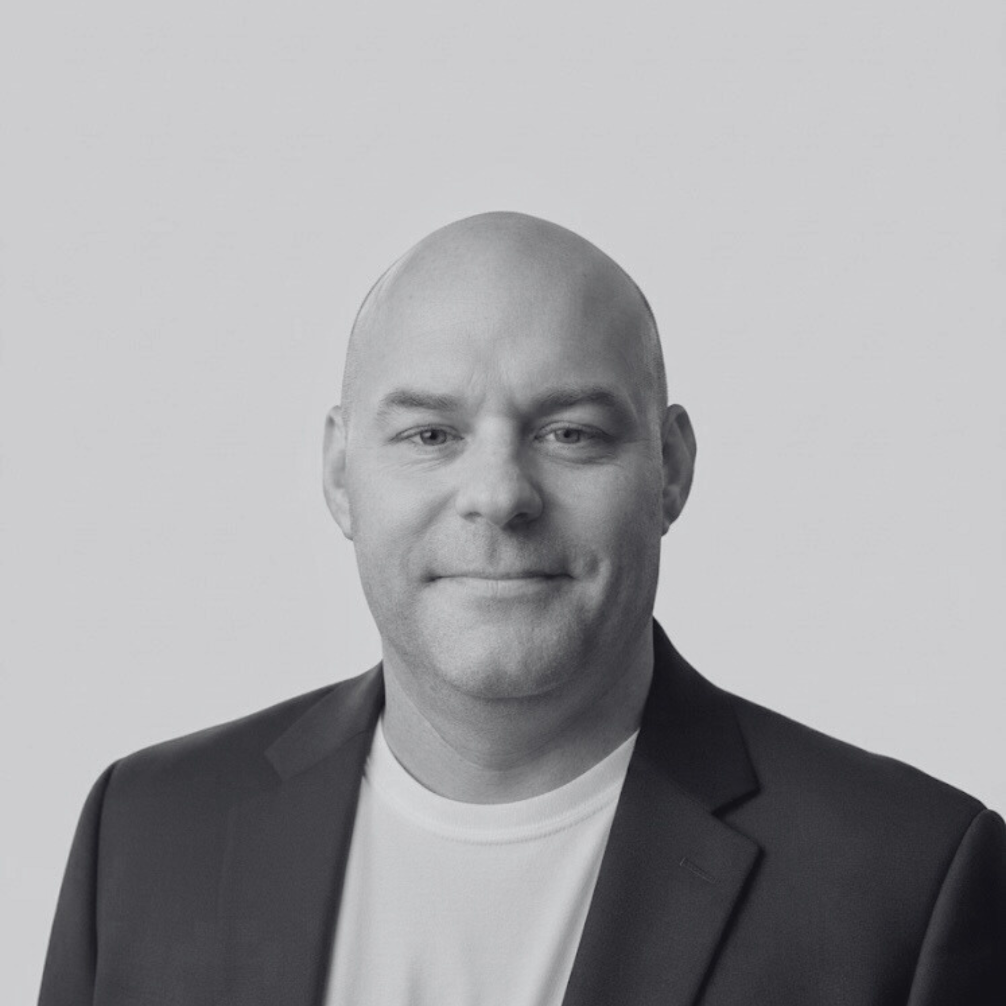 Tim Lewandowski, Founder and Managing Partner of System 2 Foundry, in a high-contrast, black-and-white executive portrait.