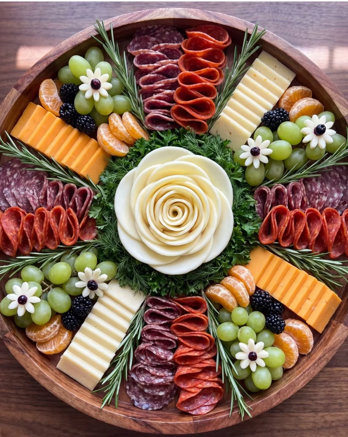 Stunning circular charcuterie grazing board with a cheese rose centrepiece, salami, pepperoni, grapes, blackberries and cheddar — perfect for events.