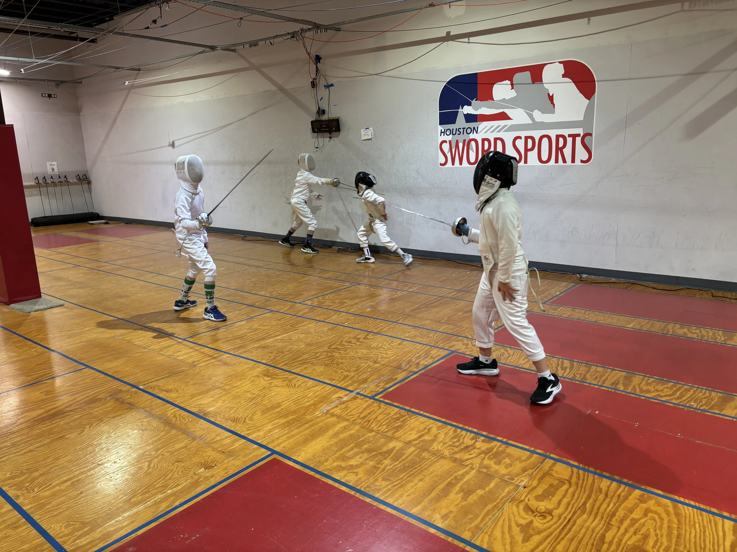 Four kids fencing epee at Houston Sword Sports