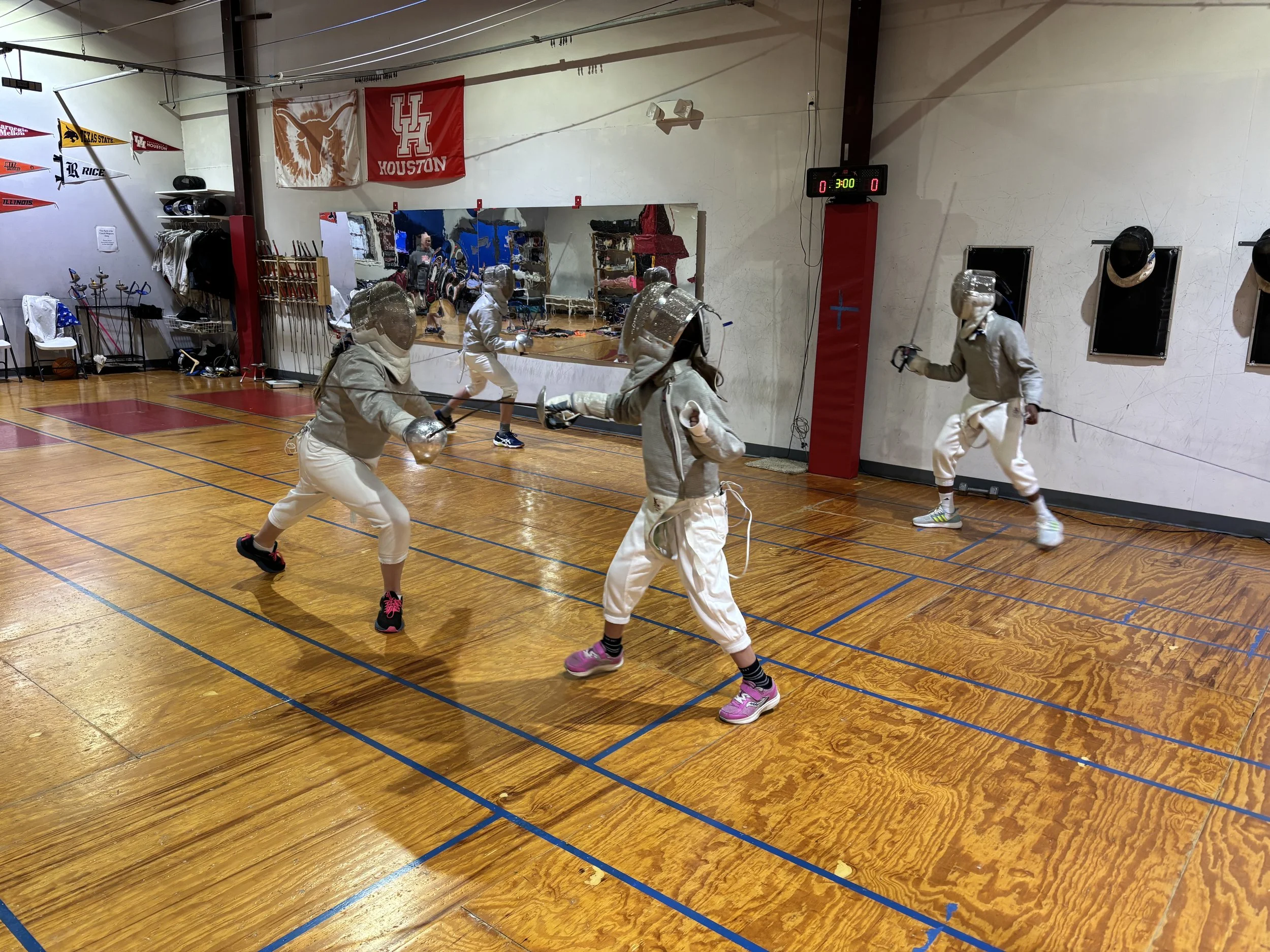 Four kids fencing saber at Houston Sword Sports