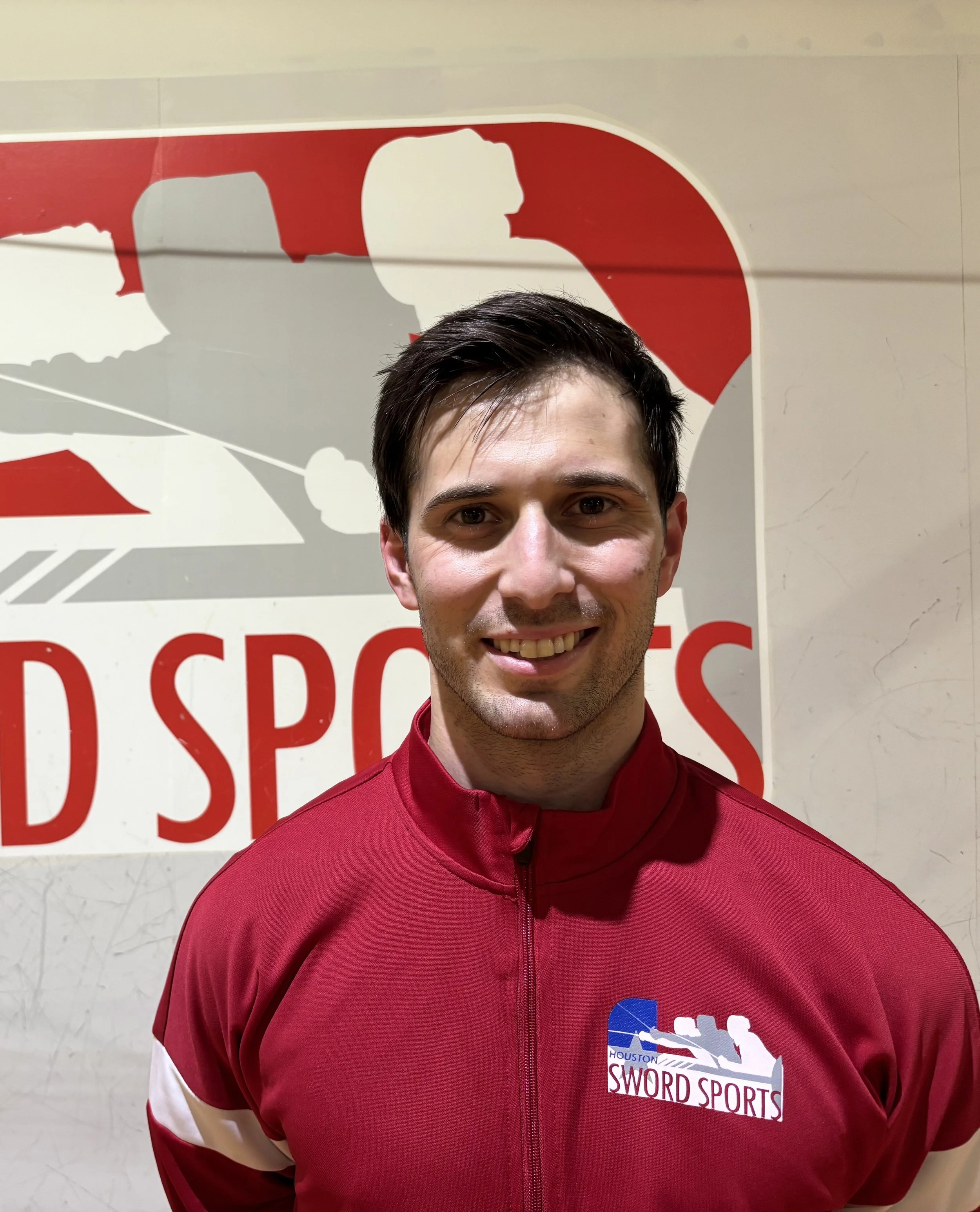 Ben Freiman standing in front of the HSS logo