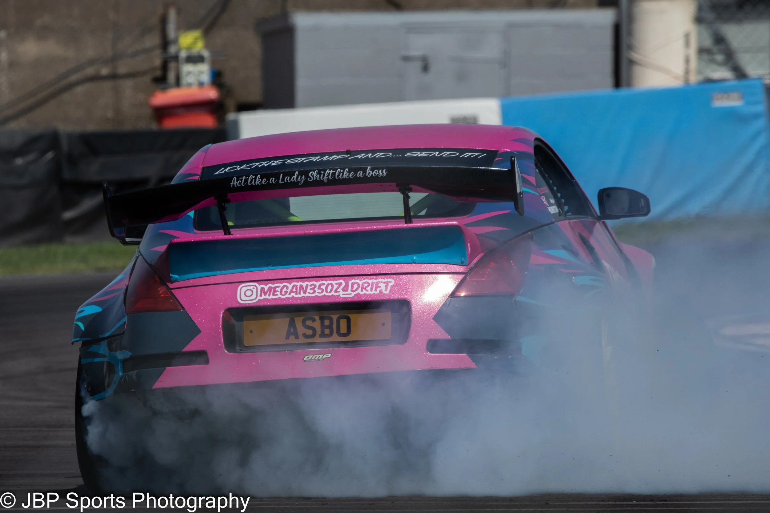 A bright pink Nissan 350z giving Drift Taxi rides at Donington Park driven by Megan Thornton