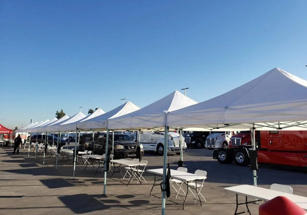 White 10 by 10 pop-up canopy set up for an event