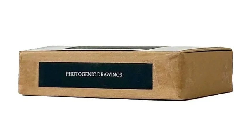 A brown paper box labeled 'Photogenic Drawings' with a black label and white text.