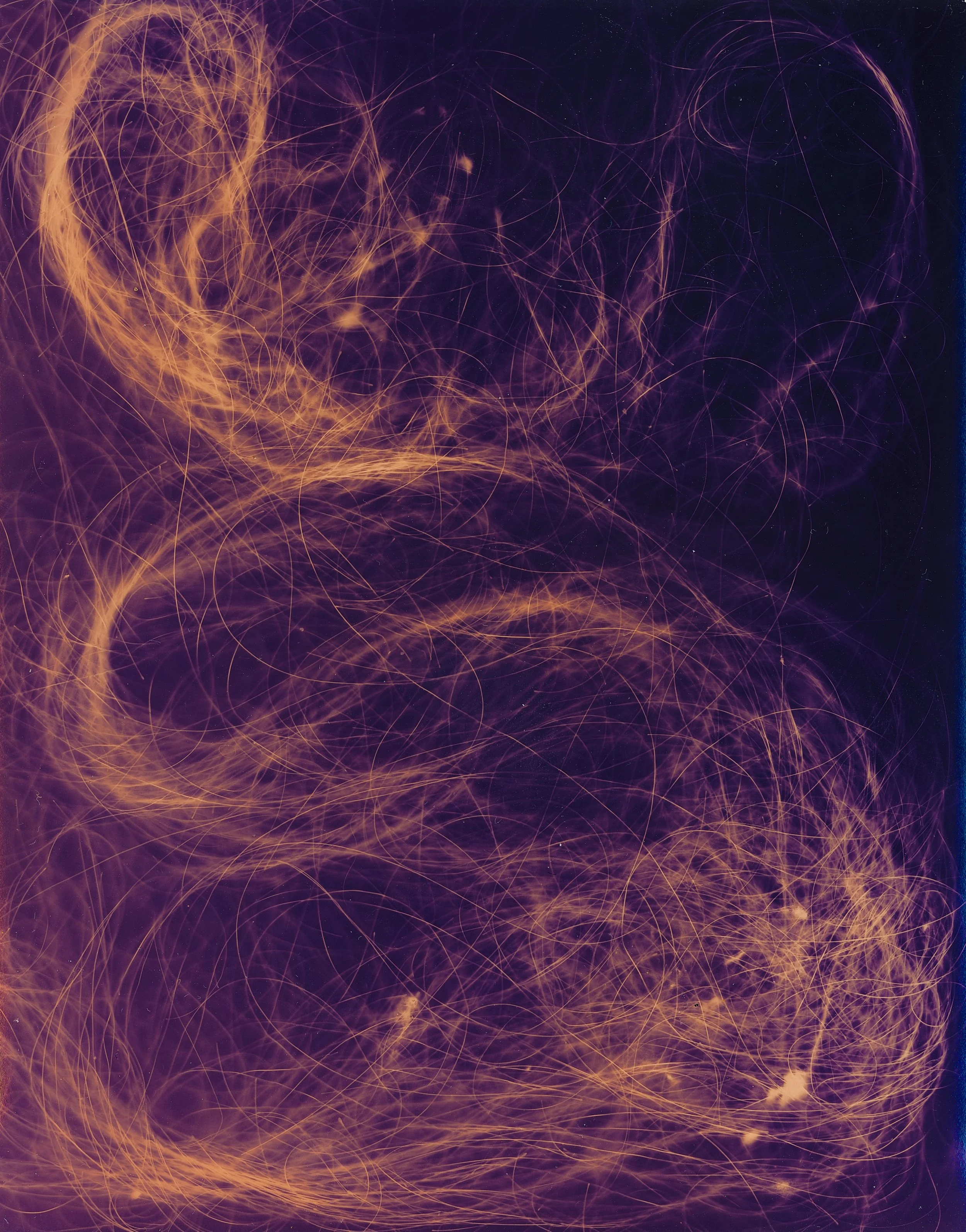 Abstract image with swirling orange and purple light lines and sparks against a dark background.
