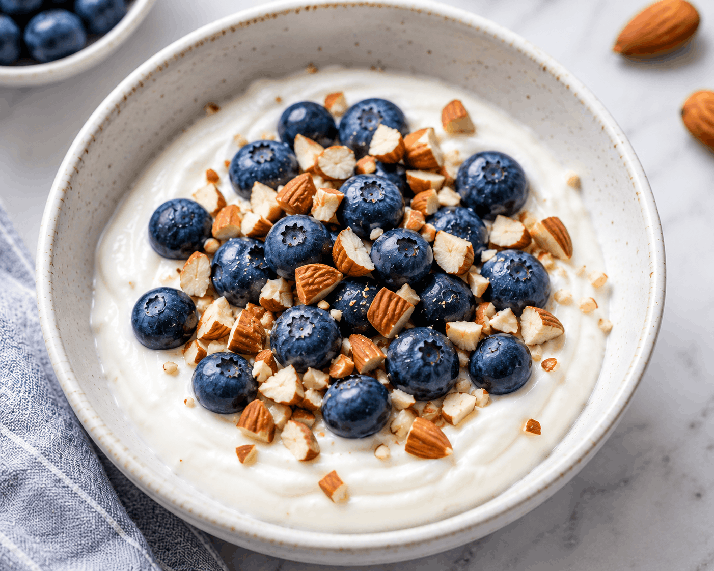 Greek yogurt protein bowl topped with fresh fruit for a healthy high-protein breakfast.