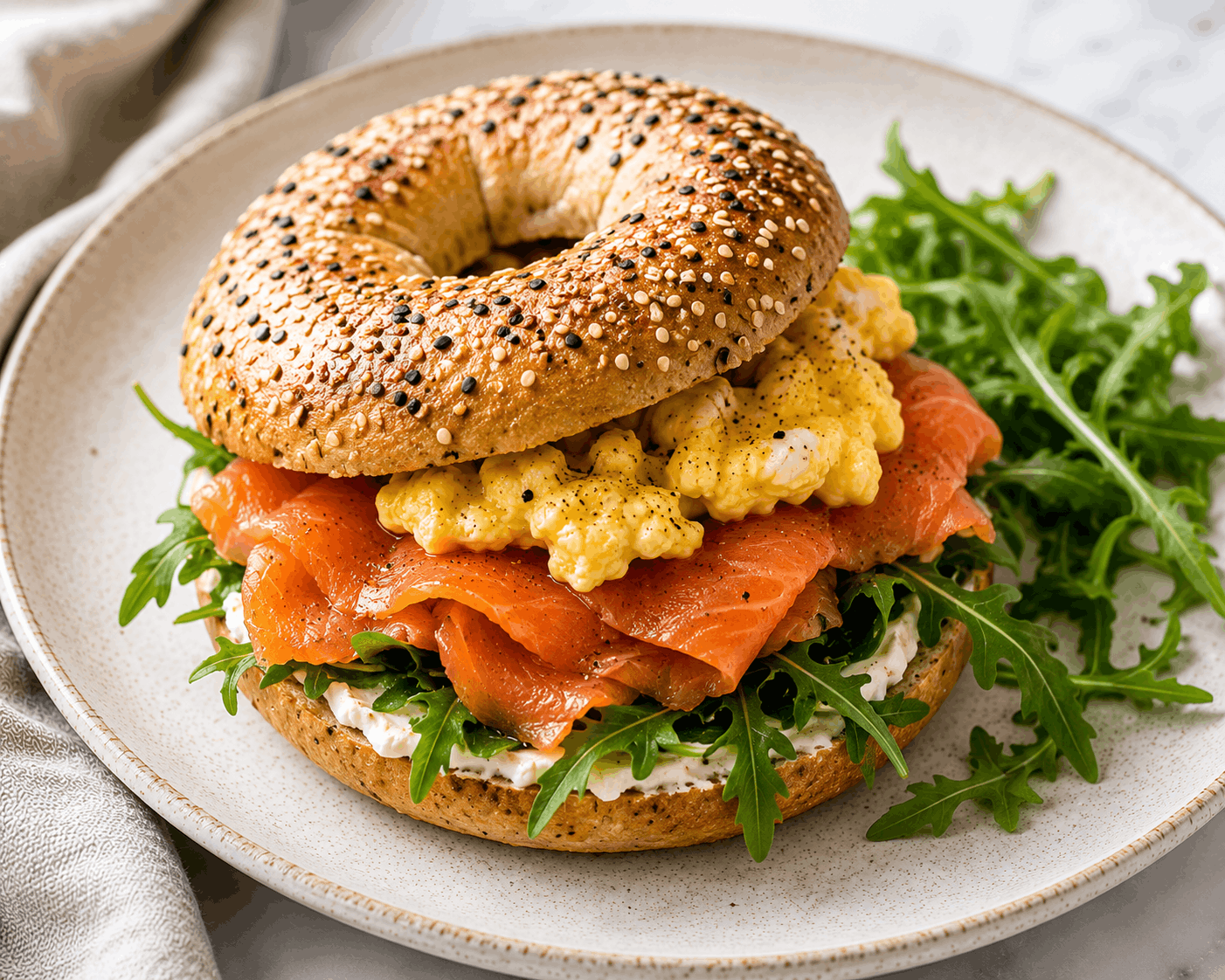 Smoked salmon and egg bagel served as a high-protein breakfast or brunch.