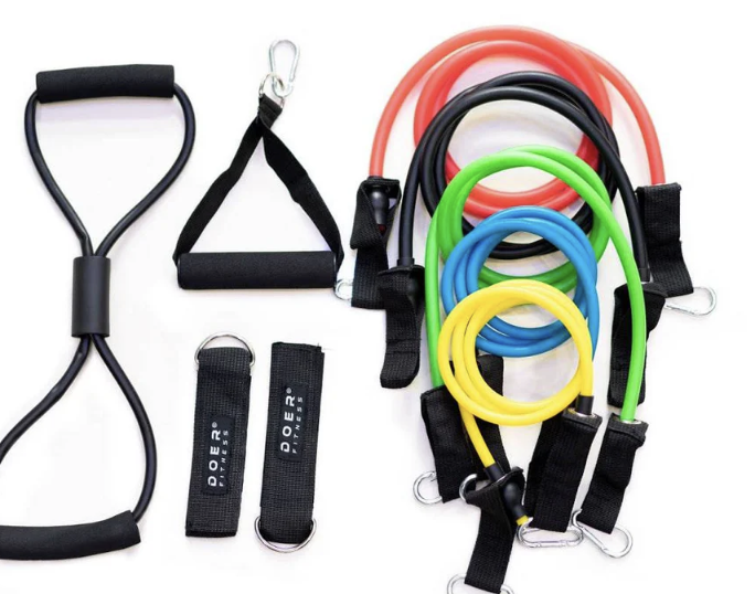 Collection of resistance bands and handles for exercise, including loop bands, door anchor, and different colored resistance bands.